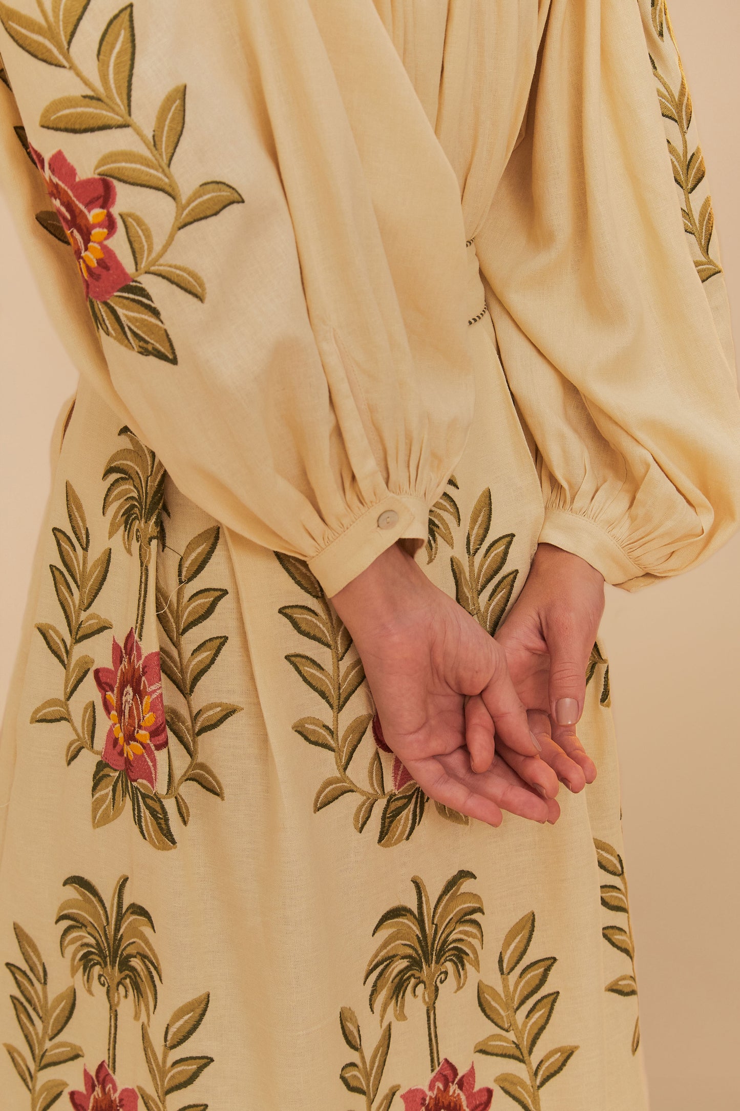 FARM Rio model wearing the Tropical Flower Embroidered Sand Long Sleeve Blouse