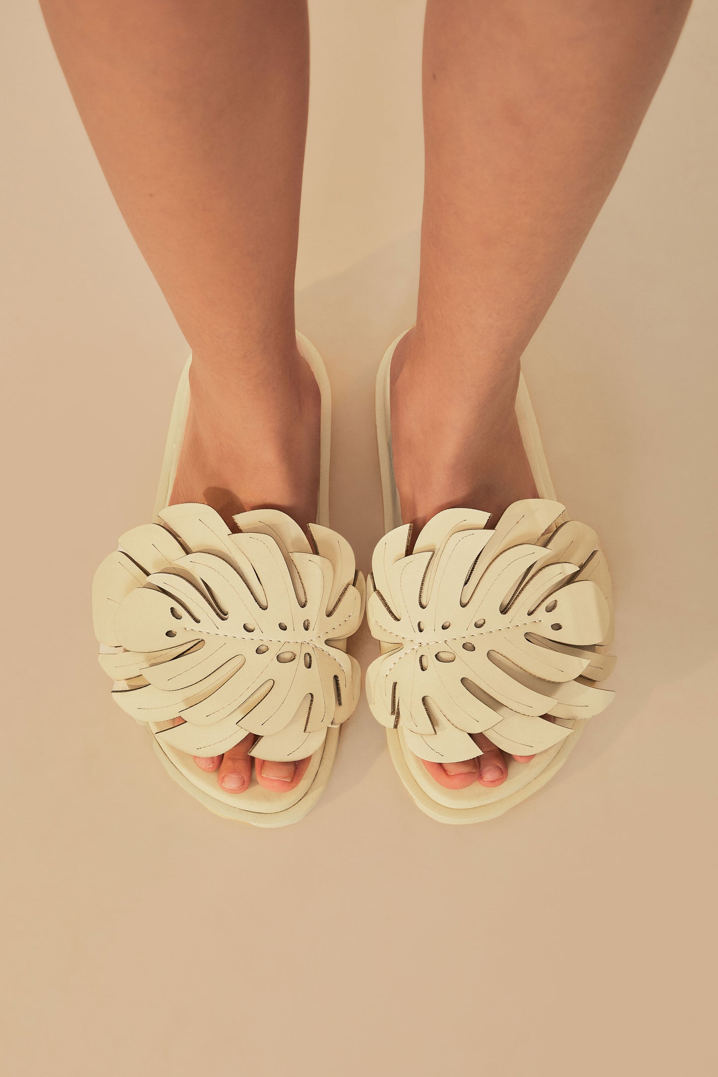 FARM Rio model wearing the Ivory Monstera Slide Sandal