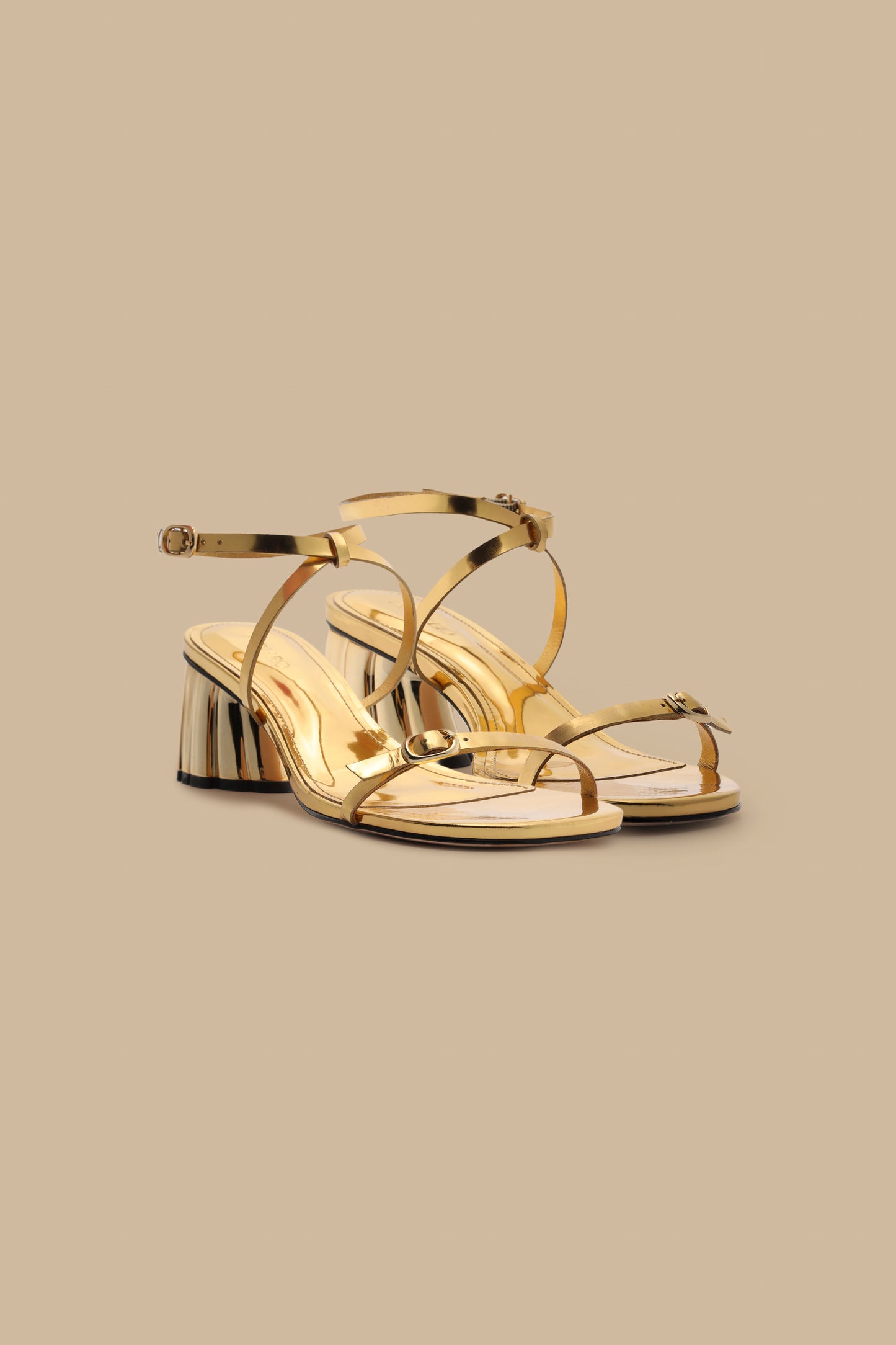 FARM Rio model wearing the Gold Monstera Heel Scalop Sandal