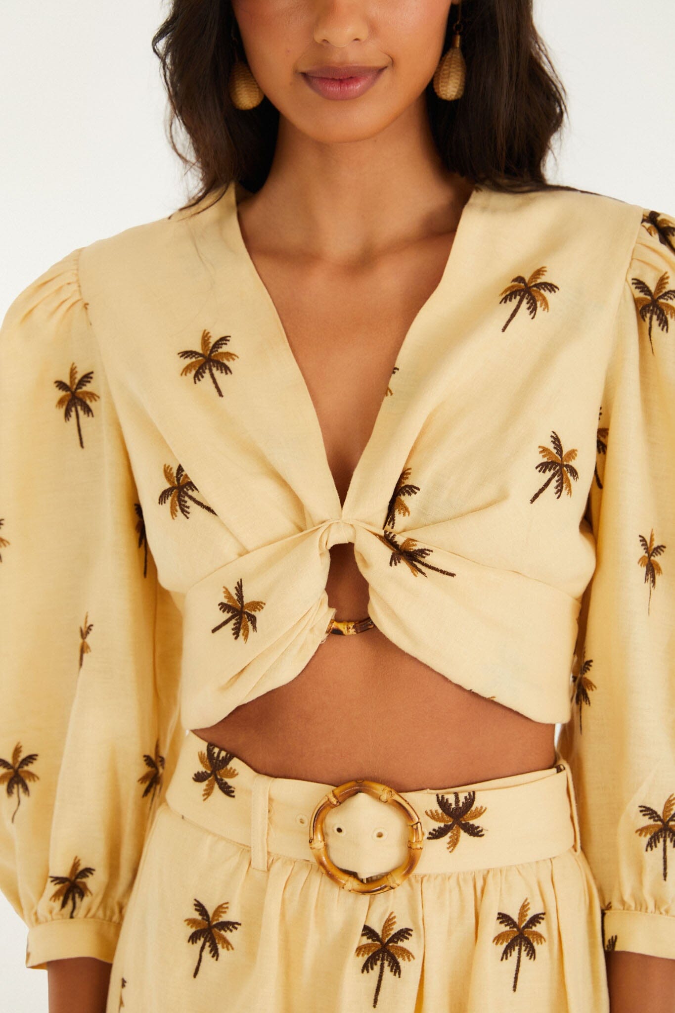 FARM Rio model wearing the Sand Embroidered Trees Buckled Long Sleeve Crop Top
