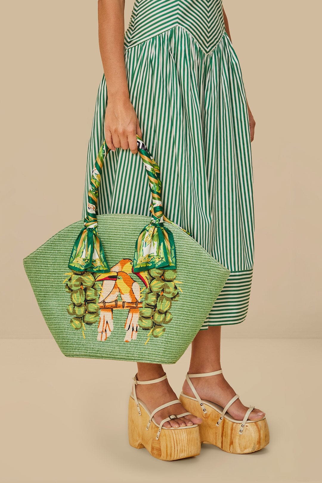 FARM Rio model wearing the Green Coconut Toucan Raffia Shell Tote