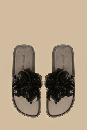 FARM Rio model wearing the Black Flower Jelly Flat Sandal